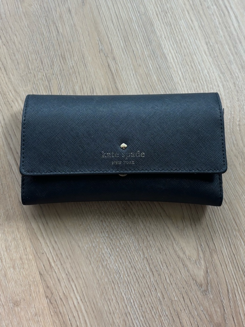 kate spade black saffiano fold-over wallet with gold logo